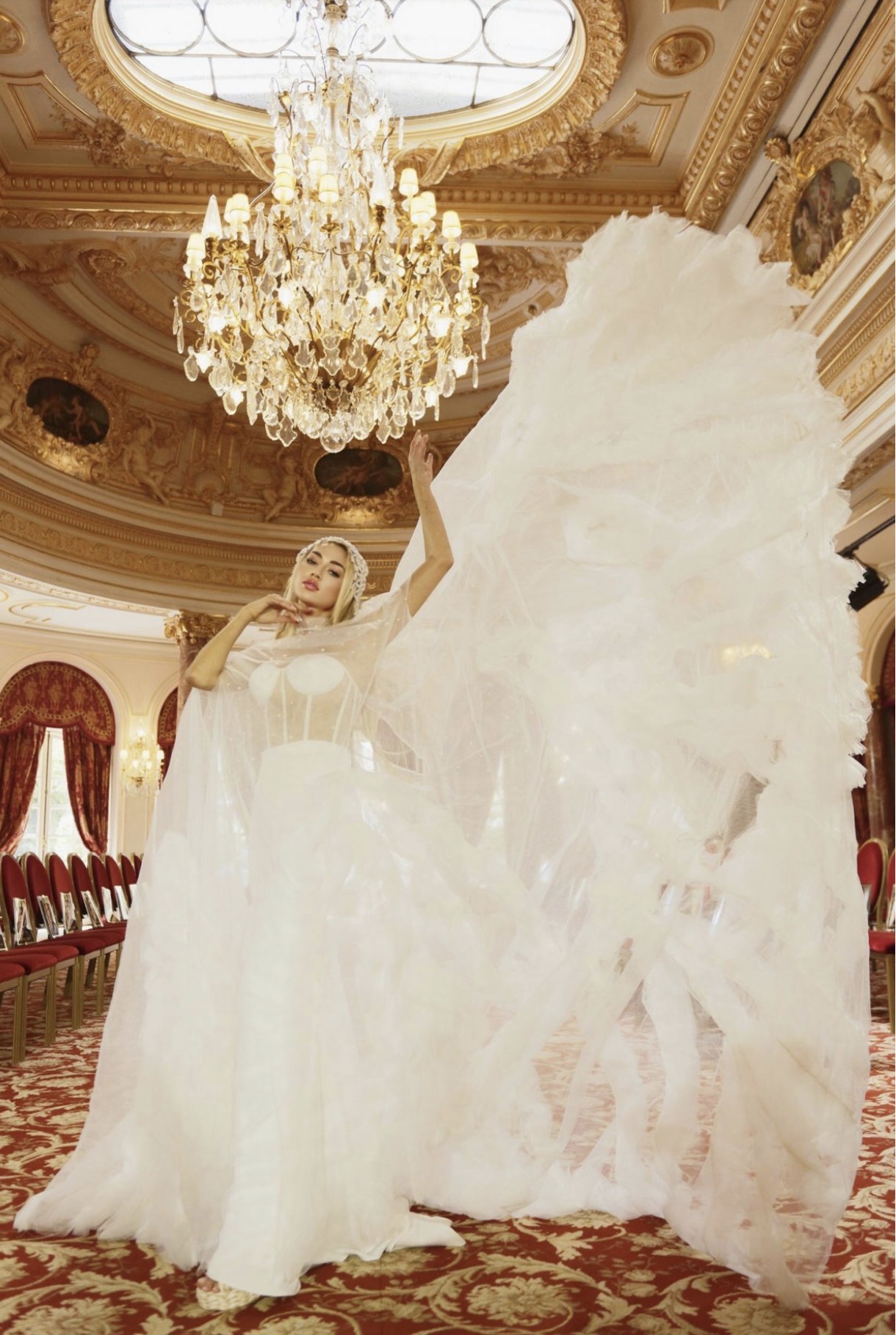 Couture gown in white tulle presented in a gilded Parisian salon at Tiffany's Fashion Week